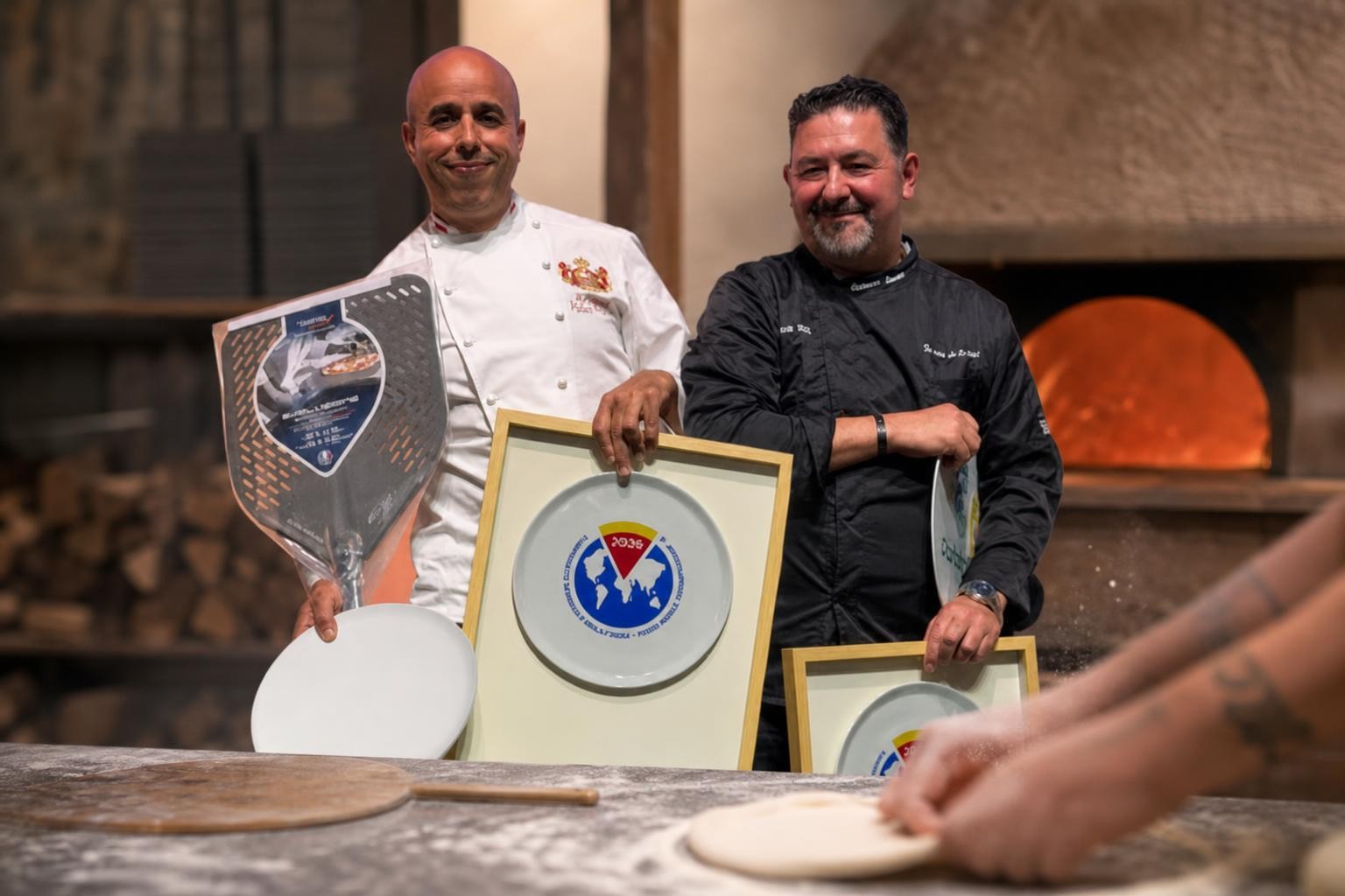 Scène de coulisses d’un concours de pizza : mains anonymes façonnant une pâte sur un plan de travail professionnel